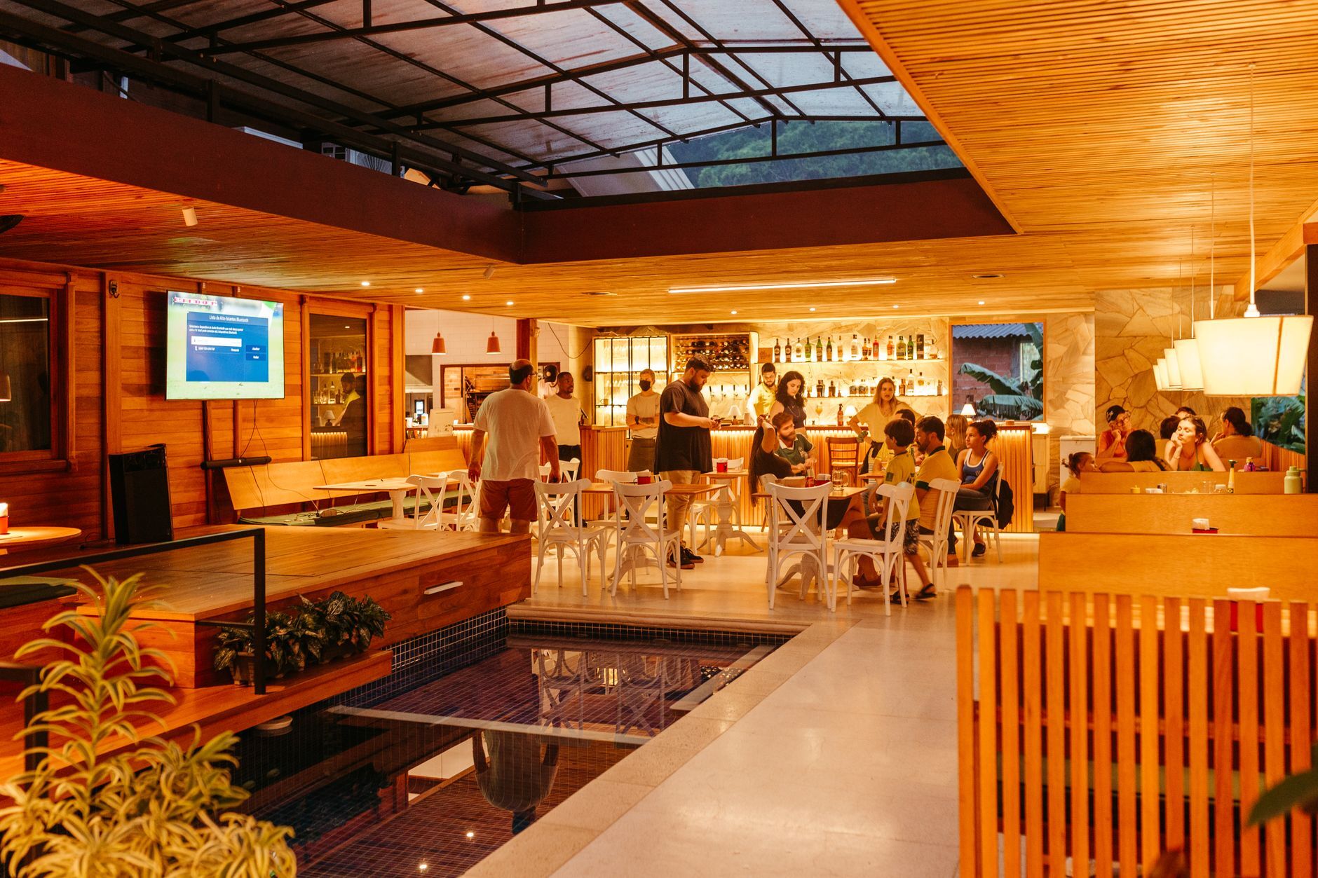 Interior of a bustling restaurant bar with people enjoying a busy evening. Photo by Jonathan Borba on Pexels