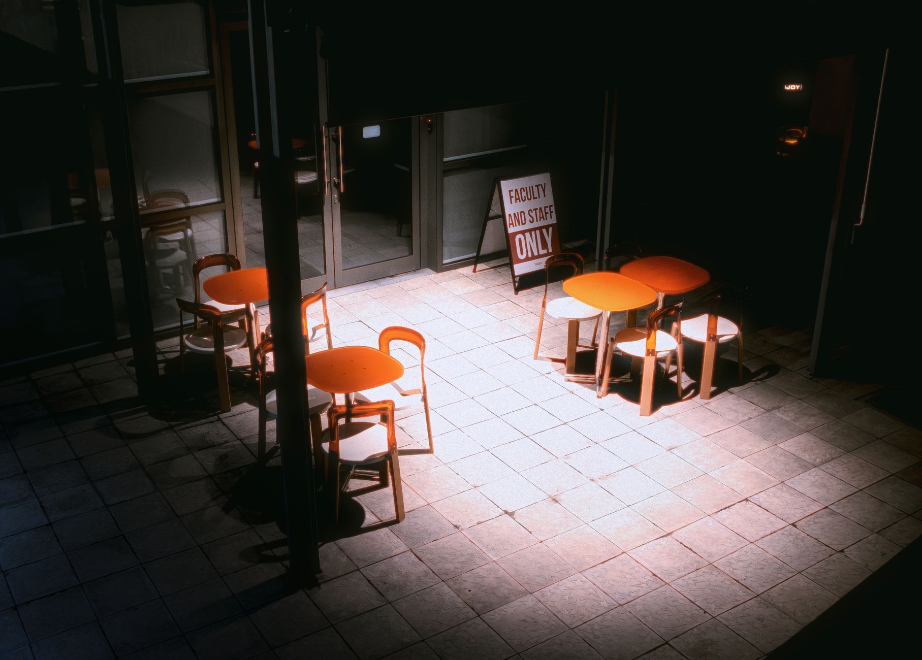 Empty restaurant patio at night with restricted access sign — illustrating after-hours phone coverage. Photo by Vova Kras on Pexels