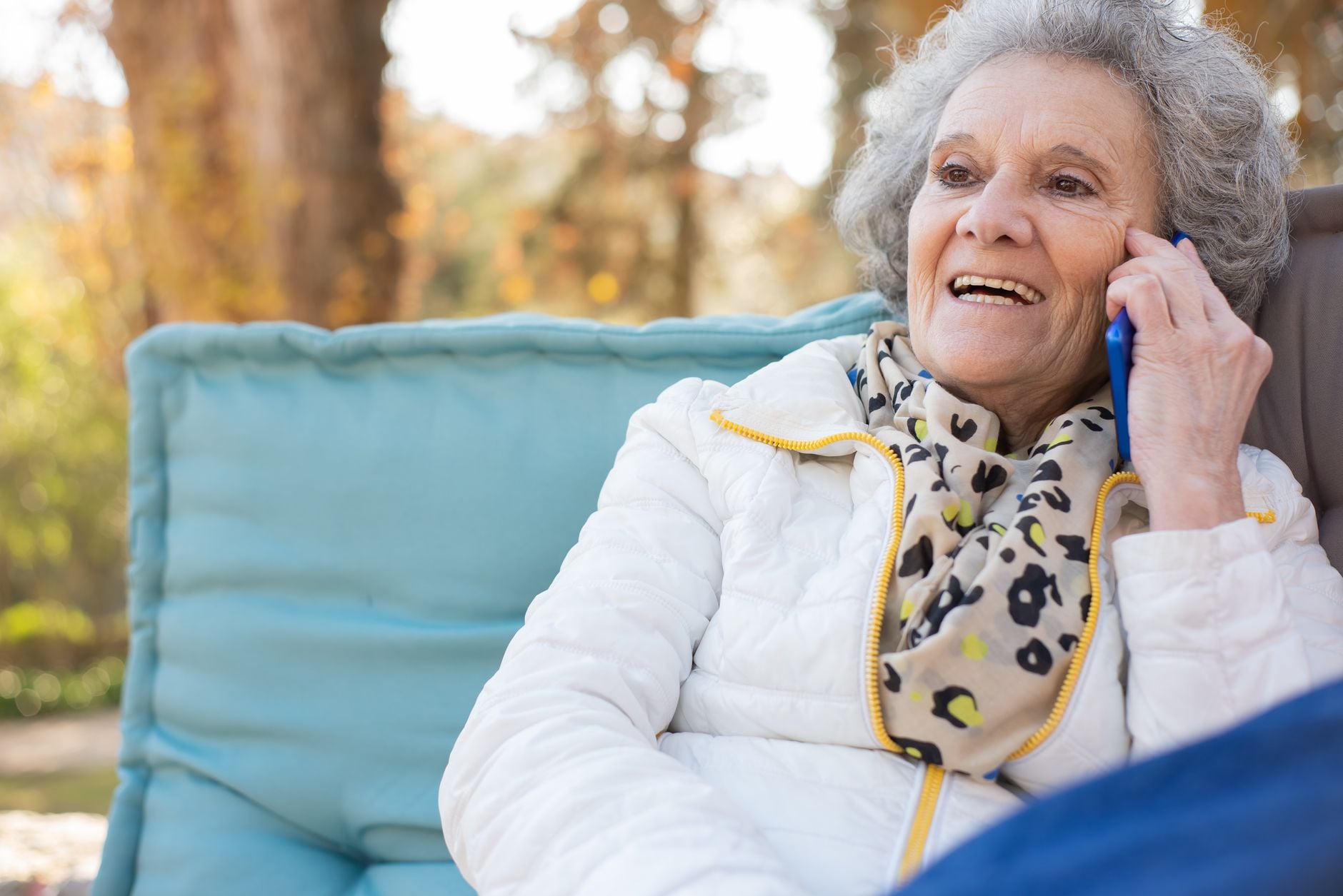 Smiling senior woman talking on her phone, enjoying a cheerful call. Photo by Kampus Production on Pexels